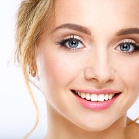 Woman with an attractive smile from cosmetic dentist.
